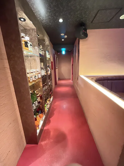 照明を受けたボトル棚と通路